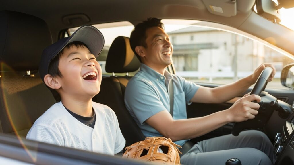 試合会場に向かう車内でリラックスして大笑いする野球親子